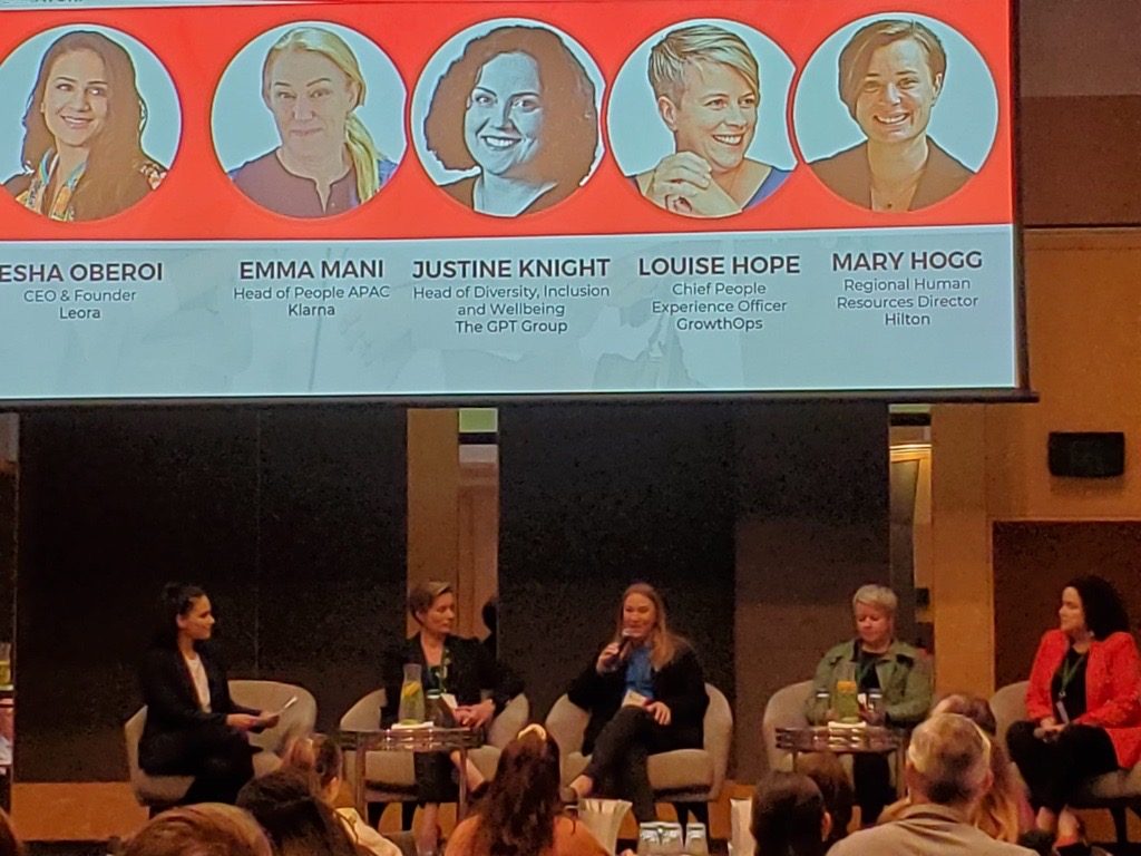 Esha on stage alongside other business leaders