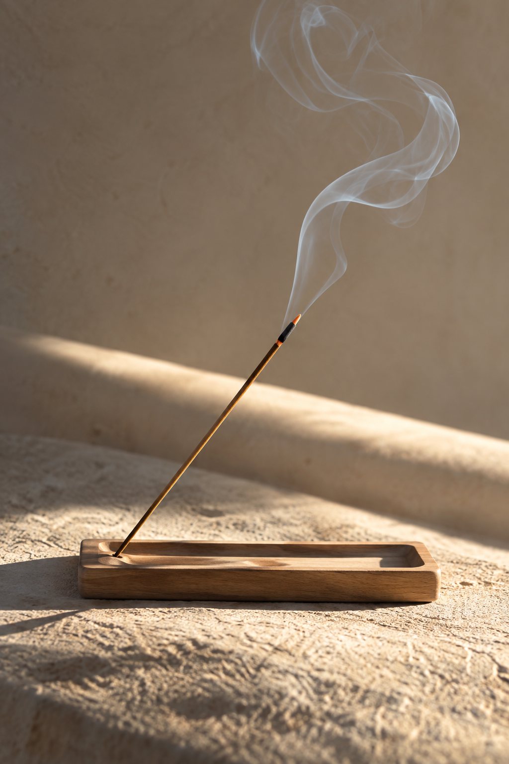 Incense smoke rising in warm sunlight