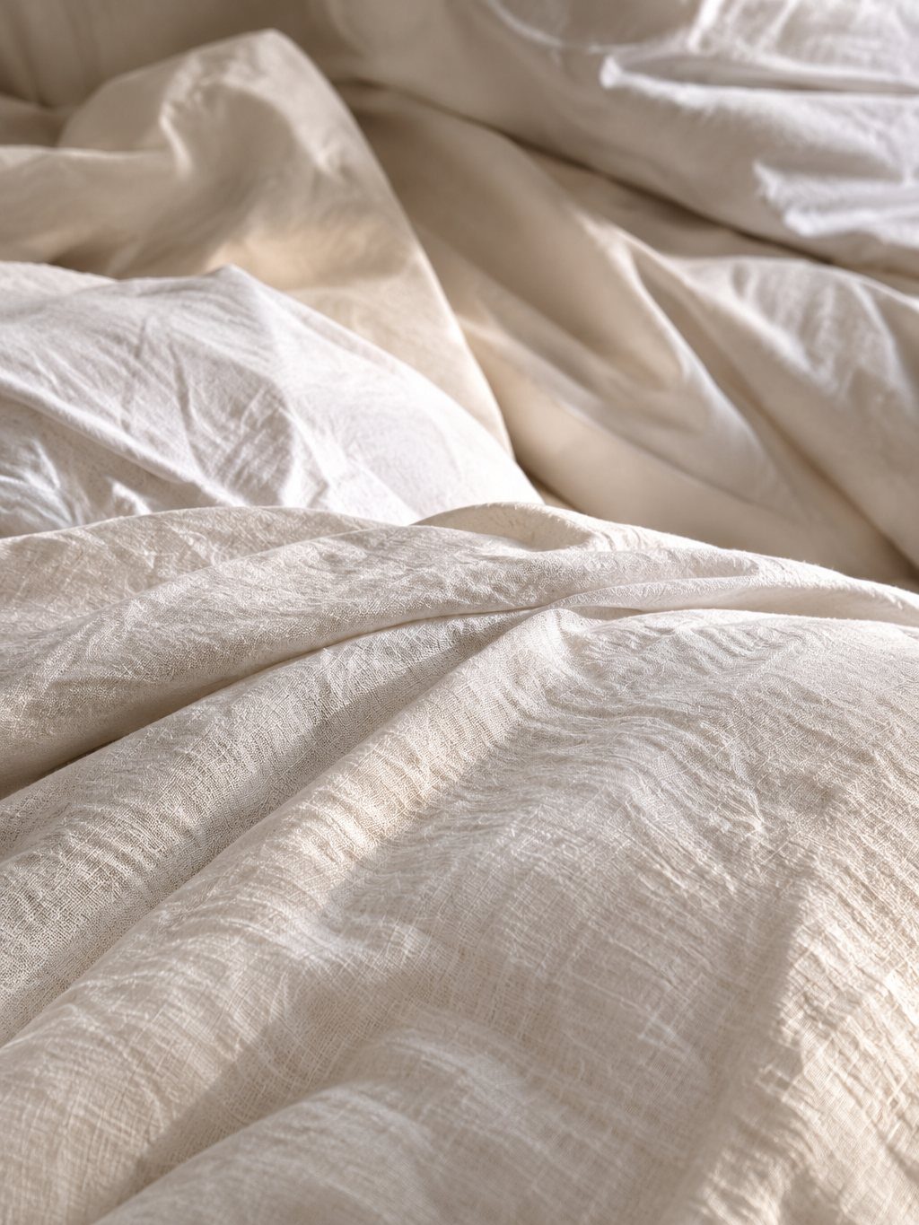 Rumpled ivory linen in soft morning light